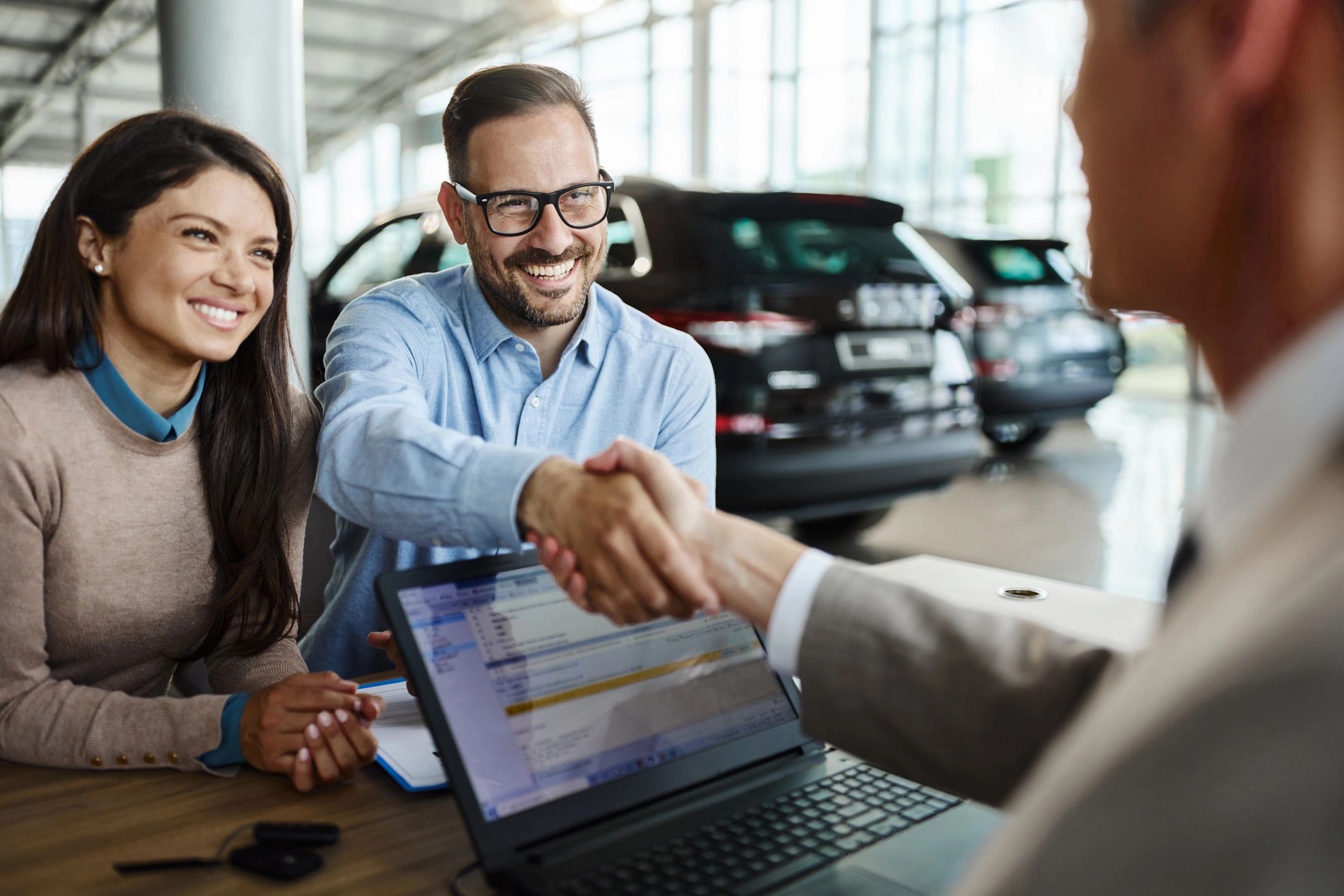 happy car buyer handshake